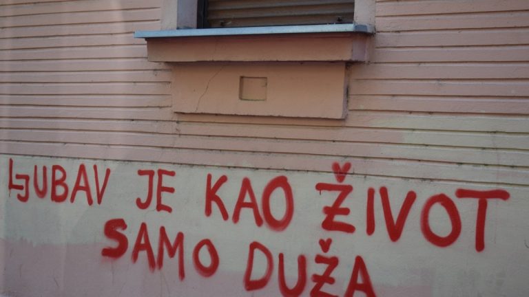 Red graffiti on a building wall